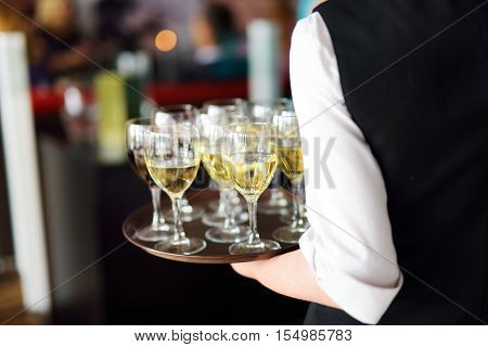 Waitress With Dish Of Champagne And Wine Glasses