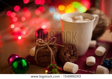 Homemade chocolate cookies with cup of cocoa and marshmallow. Christmas hot drink with tasty cookies.