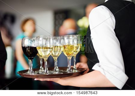 Waitress With Dish Of Champagne And Wine Glasses
