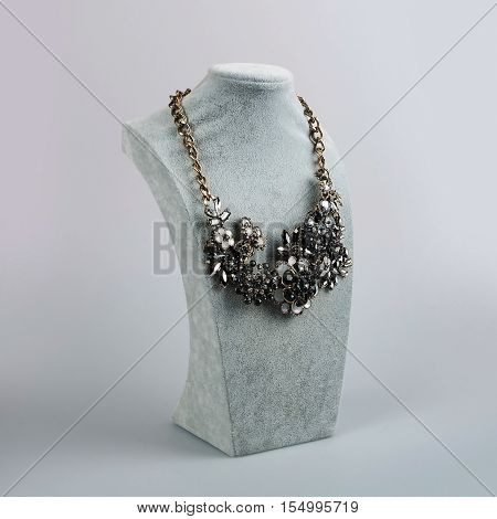 stylish female necklace in vintage stylie over grey