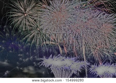 Great fireworks display at night on the occasion of the New Year. with special filter effect partialy black and white.Closehorizontal view.