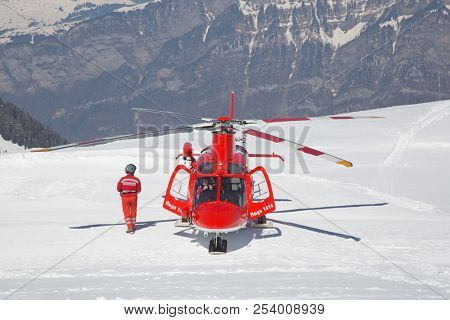 FLUMSERBERG - MARCH 25: The unidentified pilots of the swiss emergency service Rega performing training exercise in skiing area Flumserberg, Switzerland on March 25, 2018. 