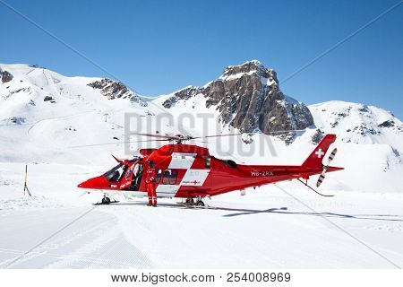 FLUMSERBERG - MARCH 25: The unidentified pilots of the swiss emergency service Rega performing training exercise in skiing area Flumserberg, Switzerland on March 25, 2018. 