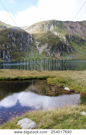 Glacial Lake - Sky And Mountains Reflected In The Water