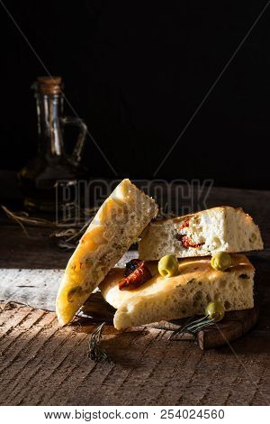Sliced Bread Ciabatta And Extra Virgin Olive Oil On Olive Wood Cookware Background. Wooden Desk. Ita