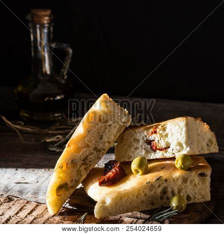Sliced Bread Ciabatta And Extra Virgin Olive Oil On Olive Wood Cookware Background. Wooden Desk. Ita