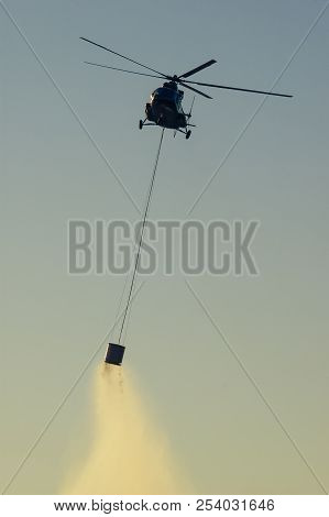 Military Helicopter Putting Out Forest Fire In Istria Croatia At Sunset