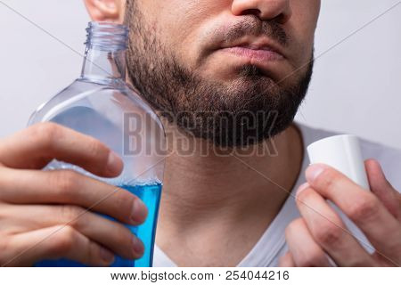 Close-up Of A Man Rinsing His Mouth With Mouthwash