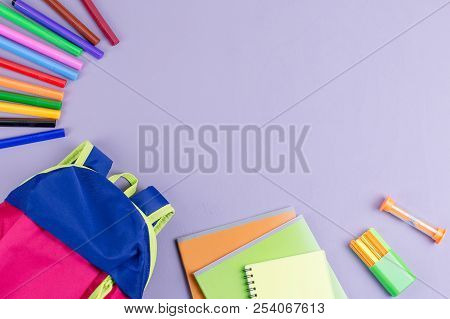 School Concept Flat Lay. Kid Backpack, Notebook, Markers On Wooden Desktop