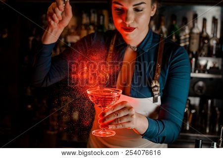 Beautiful And Sexy Female Barman With Deep Neckline Spraying Bitter On The Elegant Cocktail Glass Fi