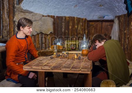 Two Men Playing Popular Strategy Board Game - Tafl