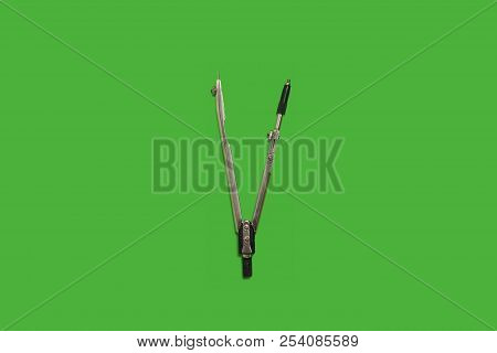 Calipers Lying On A Green Background . Concept Of Office Supplies. Free Space For Advertising Text