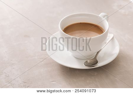 White China Cup Of Tea With Milk On A Plain Background