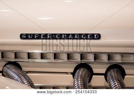 Super-charged. Retro Engine Mock-up With The Words Super Charged. Cream Paint And Chrome Pipes With 