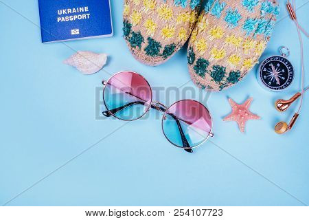 Travel Flatlay With Biometric Passport, Gradient Round Sunglasses, Earphones, Compass And Espadrille