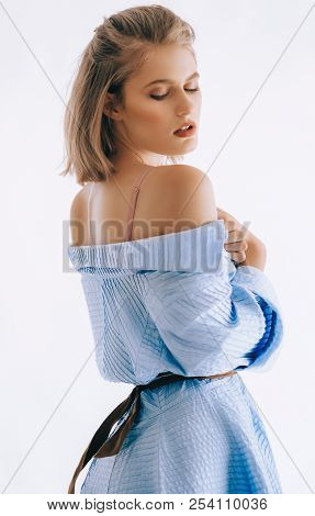 Portrait Of Beautiful Young Woman With Makeup In Fashion Blue Clothes