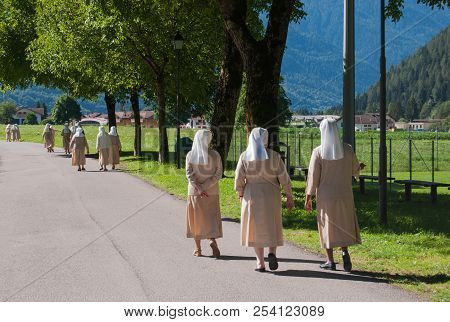 Groups Of Sisters Walking And Chatting To Each Other