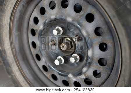 Old Rusty Car Wheel Disk With Unscrewed Bolts
