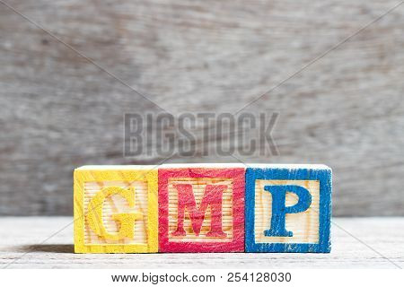 Color Letter Block In Word Gmp (abbreviation Of Good Manufacturing Practice)  On Wood Background