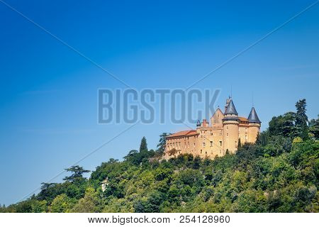 Famous Medieval Castle Of Biron Against Blue Sky