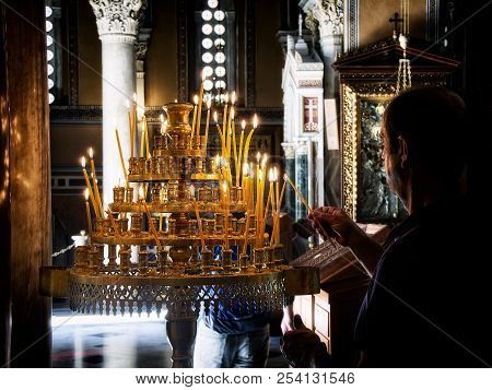 Athens, Greece - June 30, 2018. Parishioner Light Candles In The Nave Of The Metropolitan Cathedral 