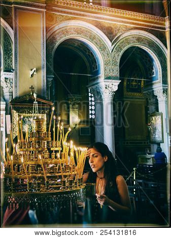 Athens, Greece - June 30, 2018. Parishioner Light Candles In The Nave Of The Metropolitan Cathedral 