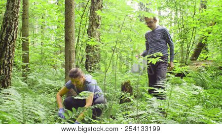 Woman And Man Ecologists Taking Samples Of A Soil