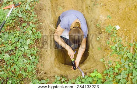 Woman Ecologist Taking Samples Of A Soil