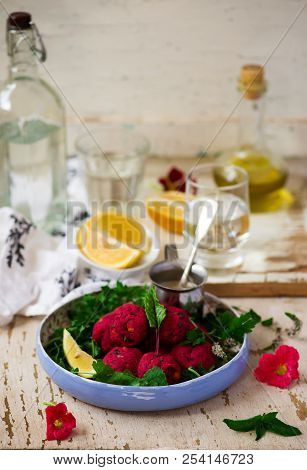 Beet Falafel With Tahina  Sauce And Green . Salad Selective Focus