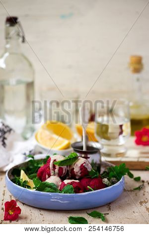 Beet Falafel With Tahina  Sauce And Green . Salad Selective Focus