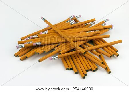 A Jumbled, Disorganized Stack Of Unsharpened, Orange, Six-sided Pencils Ready To Be Sharpened For Wr