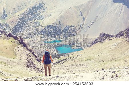 Wanderlust time. Man hiking in beautiful Fann mountains in Pamir, Tajikistan. Central Asia.