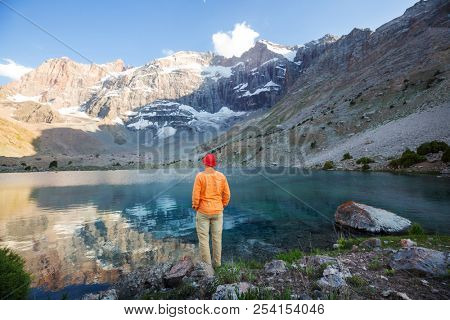 Wanderlust time. Man hiking in beautiful Fann mountains in Pamir, Tajikistan. Central Asia.