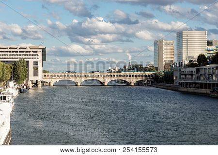 Metro Crossing Bercy Bridge With French Ministry For The Economy And Finance And National Library Of