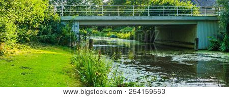 Stone Water Bridge At A River Landscape