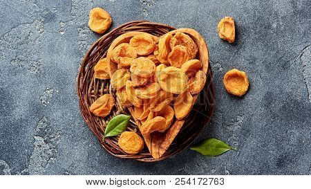 Dried Apricots On Gray Concrete Background With Copy Space. Top View.