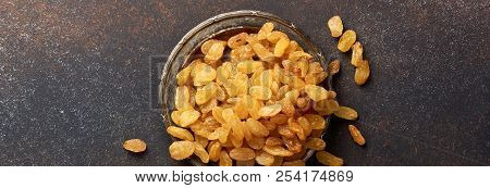 Heap Of Yellow Raisins On The Plate With Copy Space. Top View Of Dried Grapes.
