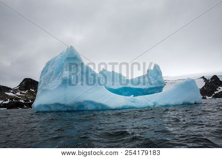 Ice In The Antarctica With Iceberg In The Ocean