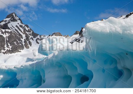 Ice In The Antarctica With Iceberg In The Ocean