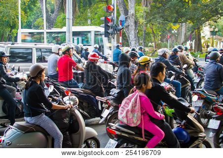 Vietnam, Hanoi, December 07, 2016: A Lot Of Motorcyclists And Vehicles Drive At The Street Of City.