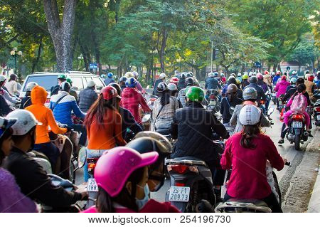 Vietnam, Hanoi, December 07, 2016: A Lot Of Motorcyclists And Vehicles Drive At The Street Of City.