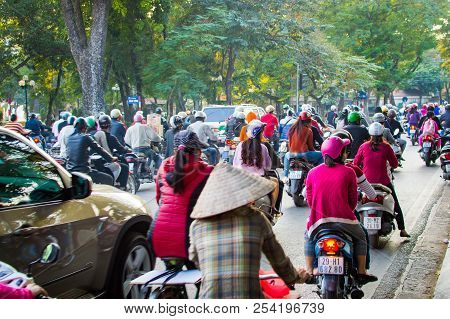 Vietnam, Hanoi, December 07, 2016: A Lot Of Motorcyclists And Vehicles Drive At The Street Of City.