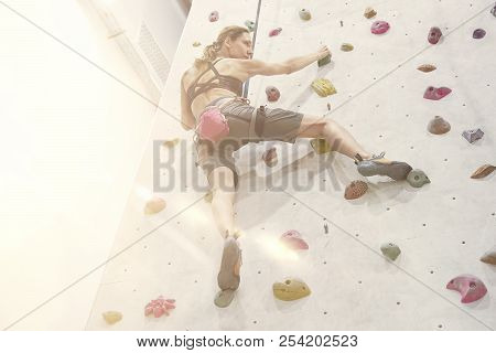 Woman With Perfect Fit Body, Beautiful Muscular Arms, Training On A Climbing Wall In Sport Hall