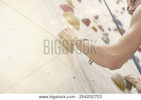 Woman With Perfect Fit Body, Beautiful Muscular Arms, Training On A Climbing Wall In Sport Hall