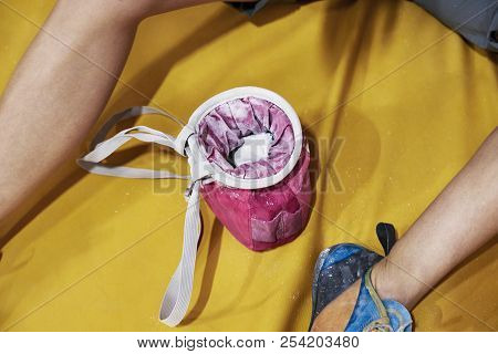 Close-up Of Female Legs, Girl On A Climbing Wall Using Magnesia, Gum Hall,  Sitting On The Floor, Ye