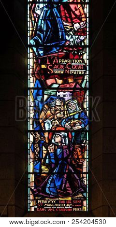 PARIS, FRANCE - JANUARY 08, 2018: Scenes from the life of Saint Margaret Mary Alacoque, stained glass window in Basilica of the Sacre Coeur, dedicated to the Sacred Heart of Jesus in Paris, France.