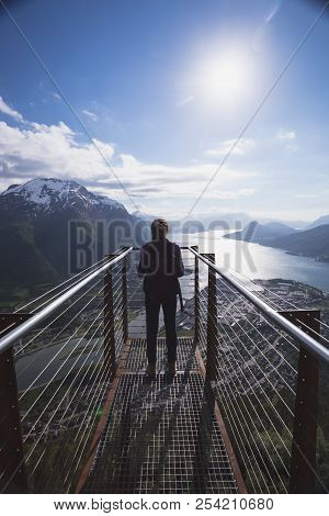 Viewpoint Rampestreken. Girl Hiker With A Backpack Standing On  Viewing Platform And Looking On Roms