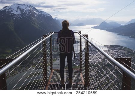 Viewpoint Rampestreken. Girl Hiker With A Backpack Standing On  Viewing Platform And Looking On Roms
