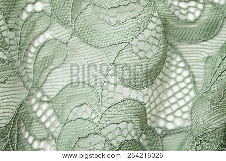 Top View Over The Green Lace Textil Texture With Ornament. Macro Shot