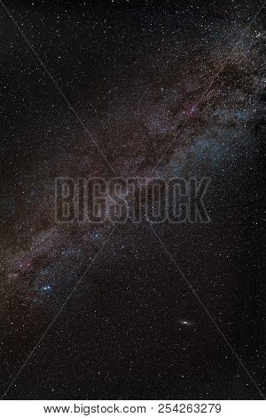 Center Of Milky Way In Night Sky With Red Nebulas And Andromeda
